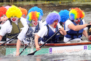 Dragon boat racing team dressed as clowns